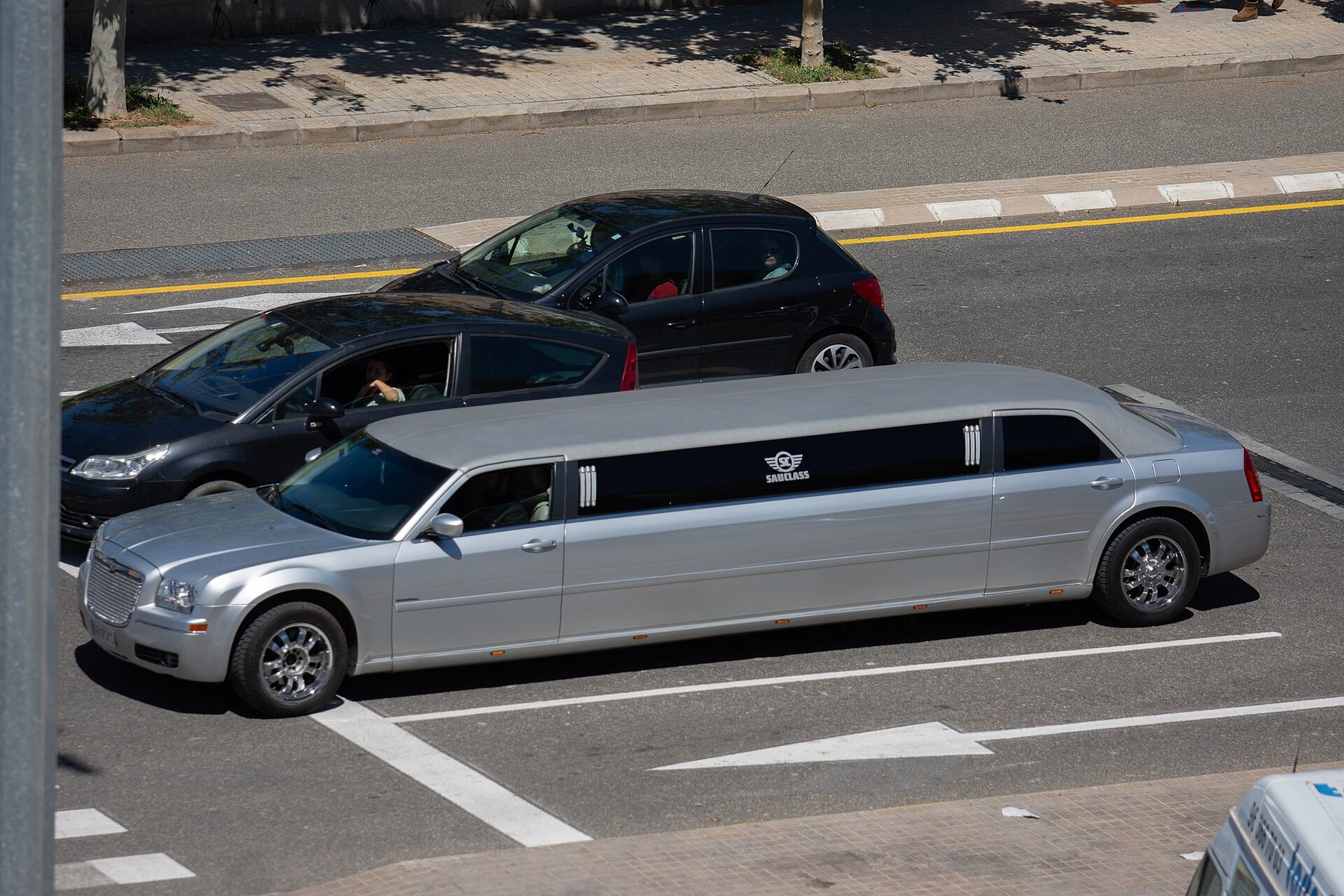 Two stretch limousines in a parking area